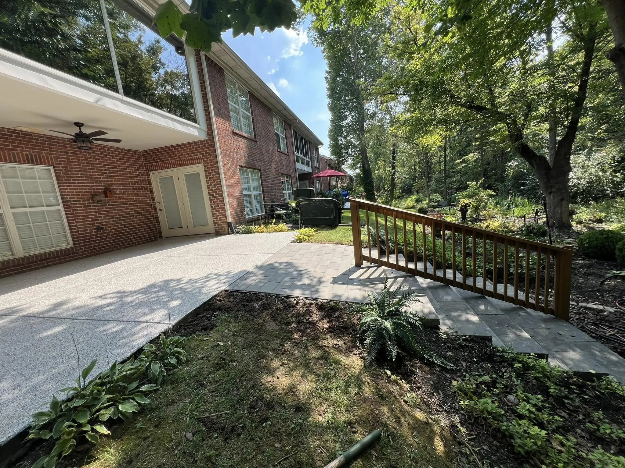 Our crew painting a covered patio and exterior brick home in Jefferson County, KY, delivering clean, professional residential painting results.